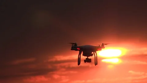Flying drone in  front of  sunset  red sky. Modern technologies and nature Stock Footage 76268906