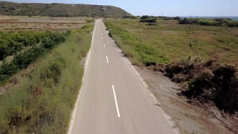 Flying by drone with high speed over a road with nature on the roadsides Stock Footage 158515243