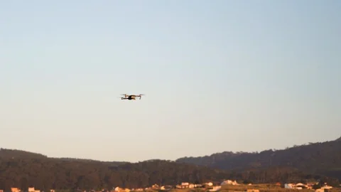 Flying drone maneuvering in flight turning around with four propellers 動画素材 110760687