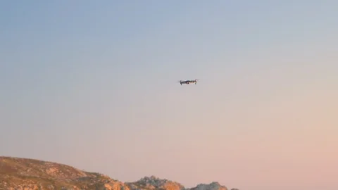 Flying drone maneuvering in flight turning around with four propellers Stock Footage 110760738