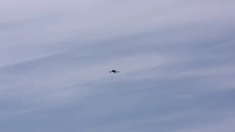 Flying drone maneuvers in slightly cloudy sky Video stock 242021263