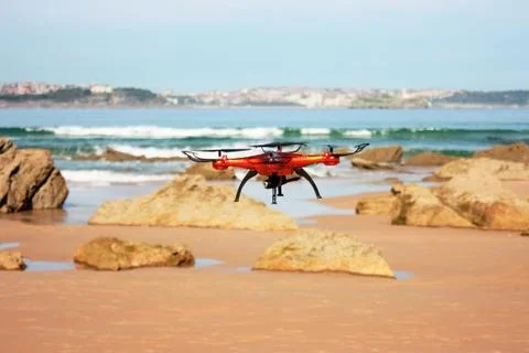 Flying drone with mounted camera on the beach Foto stock