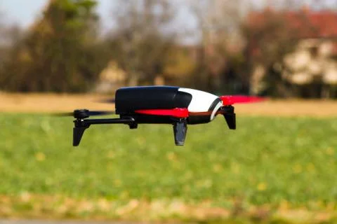 Flying drone with mounted camera over the grass Stock Photos