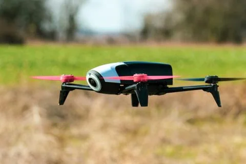 Flying drone with mounted camera in the park Stock Photos