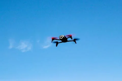 Flying drone with mounted camera in the sky Stock Photos