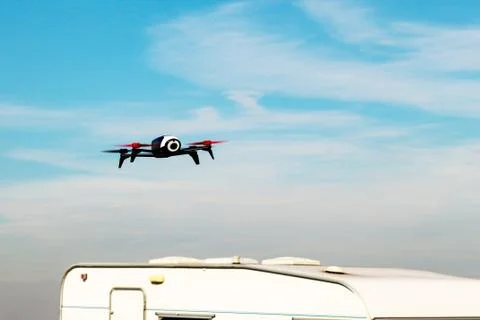 Flying drone with mounted camera in the sky Stock Photos