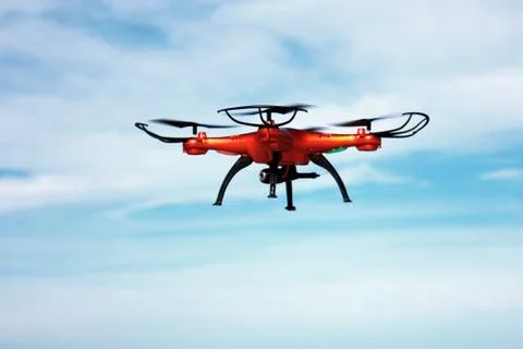 Flying drone with mounted camera in the sky Stock Photos