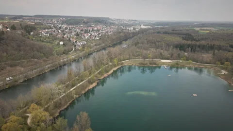 Flying drone moves forward over Danube side lake near Ulm 4K Stock Footage 328979683