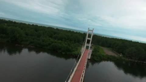 Flying a drone over the abutments of a bridge over a river Stock Footage 223945830