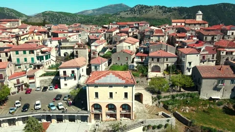 Flying a drone over an ancient small Italian town in the middle of the mountains Stock Footage 272752410