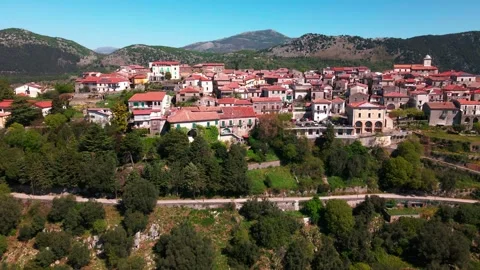 Flying a drone over an ancient small Italian town in the middle of the mountains Stock Footage 272752561