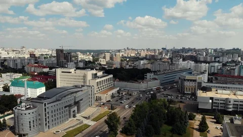 Flying drone over the central part of a city. Birds fly near the drone. Stock Footage 106187682