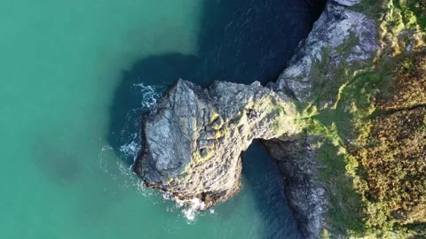 Flying drone over cliffs in Wicklow Ireland, aerial top down shot Stock Footage 168207260