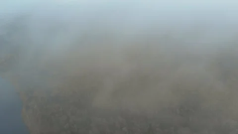 Flying a drone over the clouds. View through the fog on the picturesque autumn 库存影片 129539088