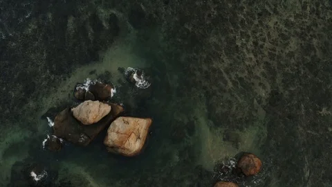 Flying a drone over the coast and Islands on the ocean at dawn. Big wave. Sunny  Stock Footage 104857671