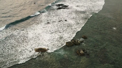 Flying a drone over the coast and Islands on the ocean at dawn. Big wave. Sunny  Stock Footage 104857694