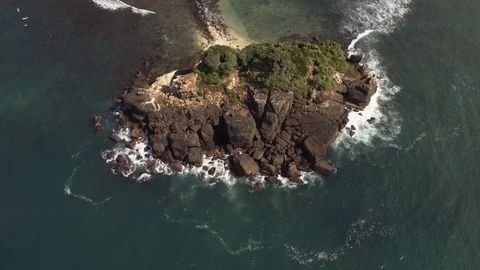Flying a drone over the coast and Islands on the ocean at dawn. Big wave. Sunny  Stock Footage 104857742