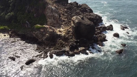 Flying a drone over the coast and Islands on the ocean at dawn. Big wave. Sunny  Stock Footage 104857797