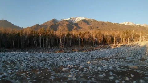 Flying a drone over a field littered with large boulders. Dolly zoom effect Stock Footage 126087657