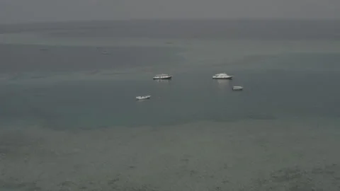 Flying a drone over a group of small boats standing on an island Stock Footage 242625357