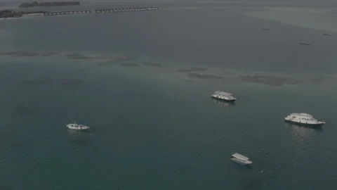 Flying a drone over a group of small boats standing on an island Stock Footage 242625494