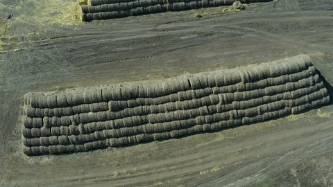 Flying on drone over haystacks next to an agro-industrial complex, grain storage Stock Footage 127718308
