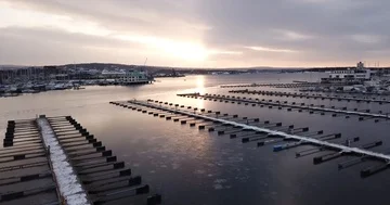 Flying drone over ice and frozen boats in Marina in Oslo, Norway Stock Footage 85866204
