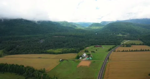 Flying drone over mountains and fields in Canada Stock Footage 204090966