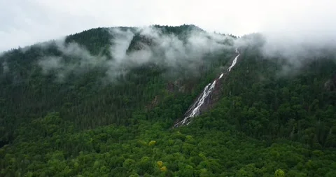 Flying drone over mountains and waterfalls in Canada Stock Footage 204091447