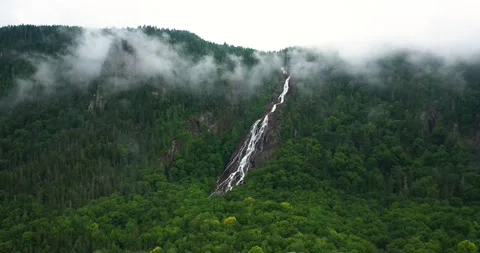 Flying drone over mountains and waterfalls in Canada Stock Footage 204091592