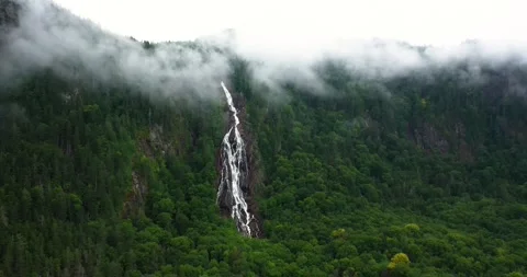 Flying drone over mountains and waterfalls in Canada Video stock 204091649