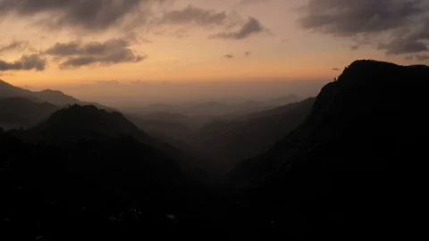 Flying on a drone over the mountains in the dawn. Big rocks. Tea plantations. Su Stock Footage 104691979