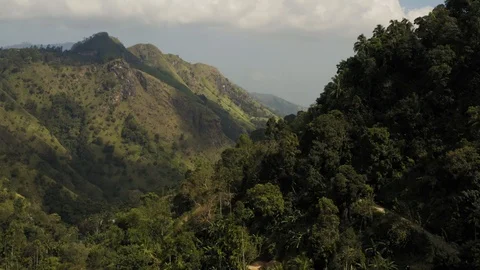 Flying on a drone over the mountains with tea plantations. Big rocks. Sunny weat Stock Footage 104691957