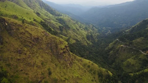 Flying on a drone over the mountains with tea plantations. Big rocks. Sunny weat Stock Footage 104857681