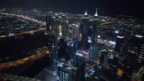 Flying a drone over a night Dubai. Aerial view Video stock 209168836