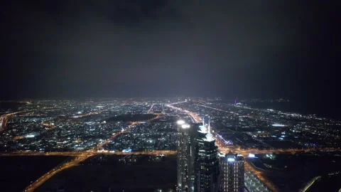 Flying a drone over a night Dubai. Aerial view Stock Footage 240550899