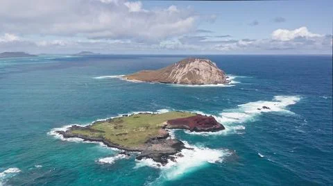 Flying drone over the ocean. View of Rabbit Island. Waves of Pacific Ocean wash Stock Photos