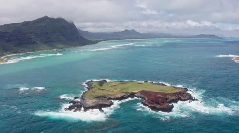 Flying drone over the ocean. View of Rabbit Island. Waves of Pacific Ocean wash Stock Photos