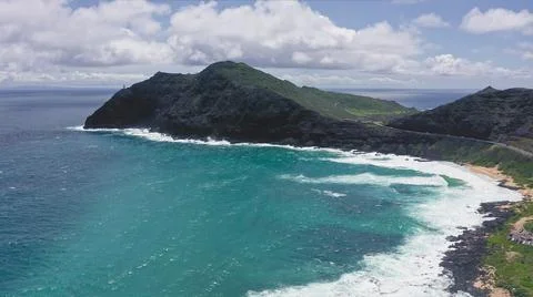 Flying drone over the ocean. View of makapuu lighthouse. Waves of Pacific Ocean Stock Photos