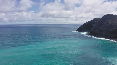 Flying drone over the ocean. View of makapuu lighthouse. Waves of Pacific Ocean Stock Photos