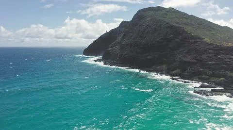 Flying drone over the ocean. View of makapuu lighthouse. Waves of Pacific Ocean Stock Photos