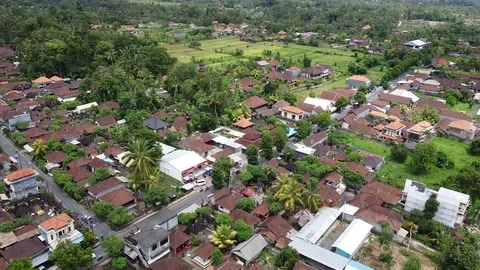 Flying with Drone over Rice Fields and Houses on island Bali - Indonesia 스톡 동영상 124907430