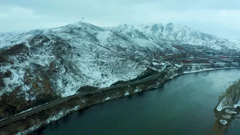 Flying a drone over the river, bridge and mountains of the city of Ust Kamenogor Stock Footage 240529479