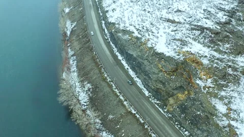 Flying a drone over the river, bridge and mountains of the city of Ust Kamenogor Stock Footage 240529723