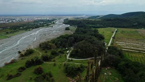 Flying a drone over a road and river in Georgia at a daytime. cloudy Stock Footage 252737874