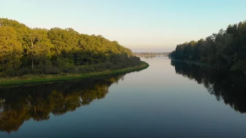 Flying a drone over a scenic spot on a winding river that reflects large, dense 動画素材 123278535