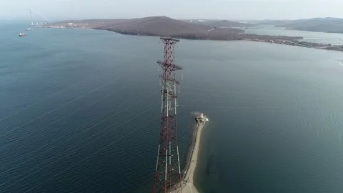 Flying a drone over the sea spit and the sea coast with a lighthouse Stock Footage 179363673