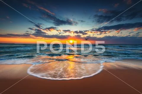 Flying drone over the sea. Sunrise shot Stock Photos