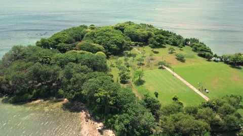 Flying a drone over a small island in the Pacific Ocean. Aerial view. Stock Footage 239234379