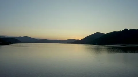Flying on drone over a sunset lake among the mountains, east Kazakhstan, Bukhtar Stock Footage 242558077